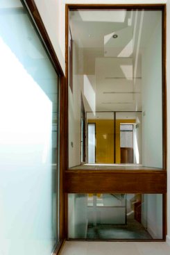 Entry into the triple height space through the timber door and large opal glass screen