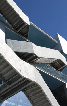 Exterior staircases hug the facade of the Campbell Sports Center, designed by Steven Holl Architects.