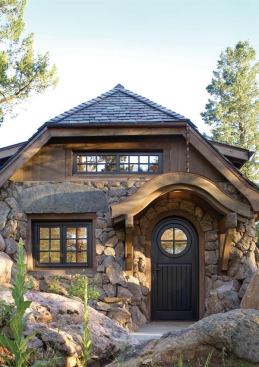 A curved front door echoed by an undulating awning offer a pitch-perfect welcome to this cozy mountain cottage. Project: Mountain Cottage, Denver area; Architect: TKP Architects, Golden, Colo.