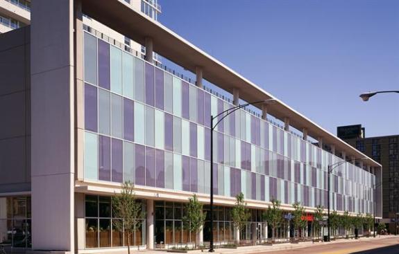 A checkerboard of aqua-hued rectangles helps turn the parking garage into a design asset.