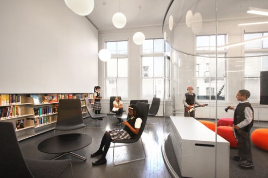 A glass-enclosed Media Vitrine puts students on center stage within the library.