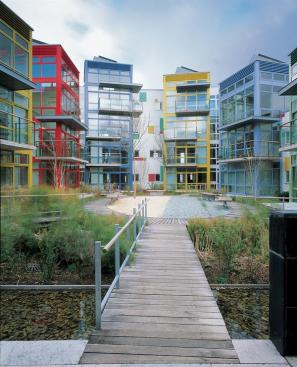 The building's energy-efficient skin includes triple-layer glass, precast concrete, zinc panels, and aluminum. Canals and pollution-absorbing plants help to cleanse the former brownfield site.