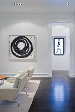 White walls and dark floors work with the specially designed lighting to show off the art to its best advantage.