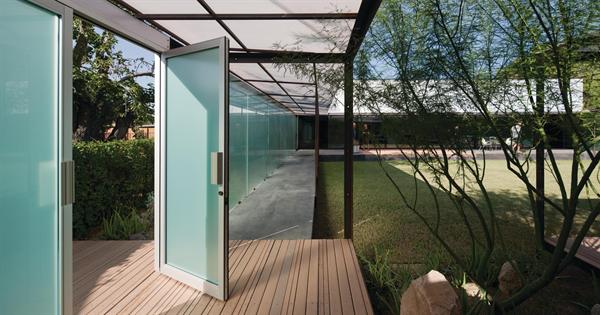 The garden wall encloses a hidden courtyard with a separate pavilion that houses both daytime living spaces and the owners architecture studio.