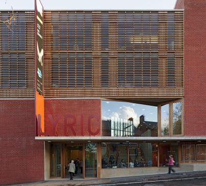 In playing to the theatre's domestic surroundings, Dublin-based firm O'Donnell + Tuomey chose to use the distinctive red 'Belfast brick' both on the interior and exterior of the Lyric Theatre. The theatre is one of the few public buildings nestled on a street tightly-knit houses.