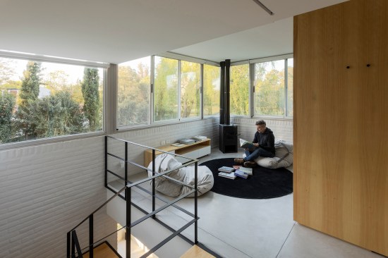 On the upper floor plywood partitions organize some informal spaces