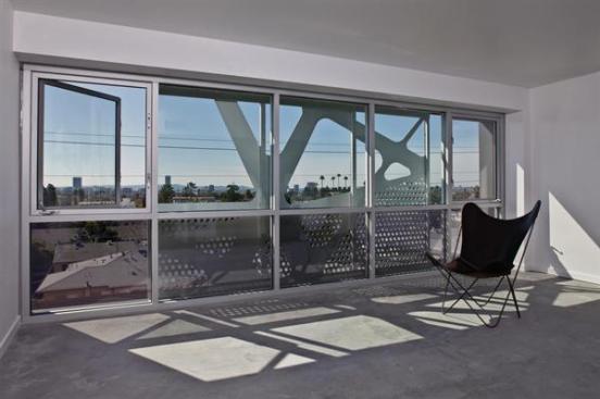 The metal screen supplies shading while permitting light and fresh air into the units.