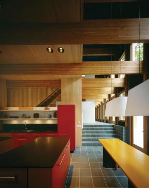 The house steps down toward the lakeshore, following the slope of the site. 