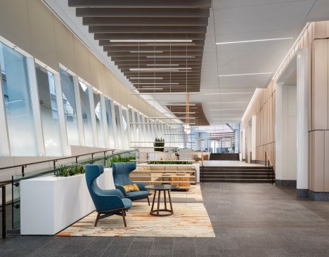 Custom light sticks pass through to the lobby ceiling to complement the interior wood baffles.