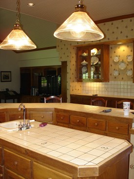 Before: The old tile-topped island and peninsula was outdated and enclosed the work space.  