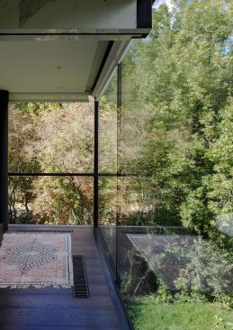 Every room boosts two glass walls, allowing the light to flow freely throughout the property.