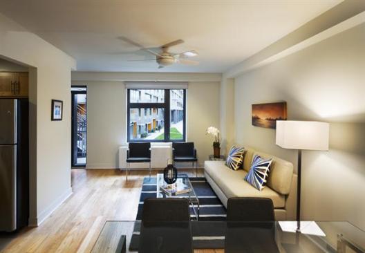 A typical townhouse unit. Ceiling fans and dual-fa?ade operable windows encourage natural cooling through cross-ventilation.