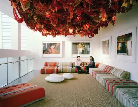 A second-floor studio accomodates gathering space under a ceiling-mounted installation.