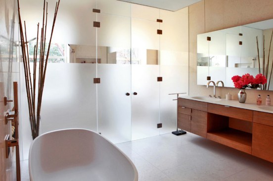 This+West+Village+master+bathroom+celebrates+the+ritual+act+of+bathing.+The+tub+is+sculpted+with+natural+curves.+A+translucent+glass+separates+the+shower+and+toilet+yet+diffuses+light+into+the+bath%e2%80%99s+inner+sanctum.