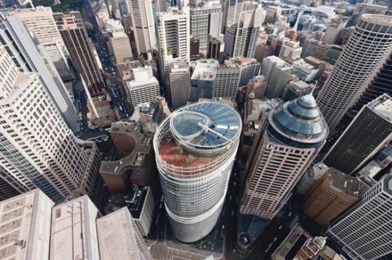 The building has a roof deck on level 28, solar thermal panels, and a grid-shell skylight that tops the glass-and-aluminum-lined central atrium.
