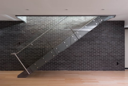 Stairs to media room with tempered glass guard