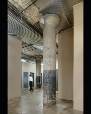 Walls jog around existing columns with mushroom capitals. 
