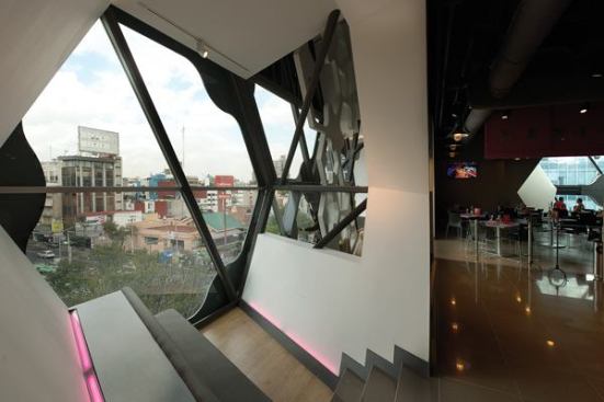 Throughout, the hexagonal pods are programmed for different uses. The upholstered bench seen here provides a seating area for customers waiting for a table in the adjacent restaurant.