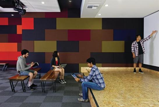 The+ground-floor+office+suites+are+oriented+around+common+resources%2c+such+as+this+multipurpose+presentation+room.+Here%2c+colorful+acoustic+panels+in+different+thicknesses+line+one+wall+to+absorb+sound+while+still+adding+texture+to+the+space.