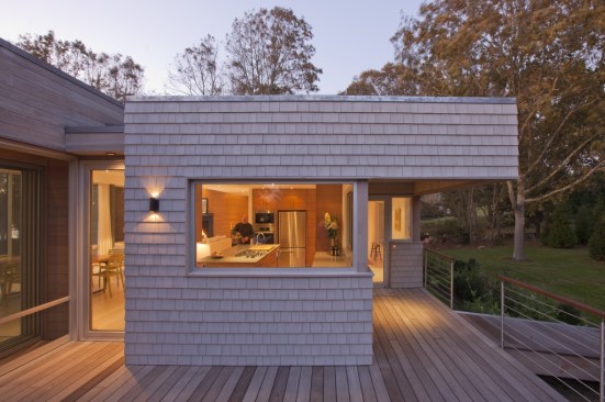 The kitchen is visible from the entry/grilling deck