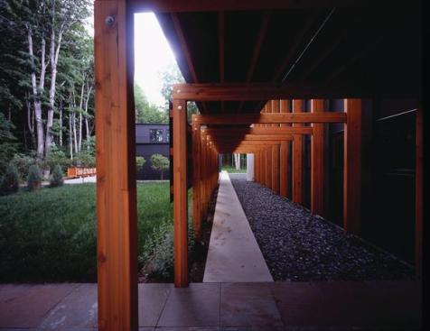 The entry trellis maintains the rhythm of the houses main structural frame.