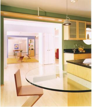 Subtle low-voltage strip lights illuminate the maple-covered hallway soffit. The liberal use ofglass throughout the house and a living room skylight allowsunlight to stream into each space.