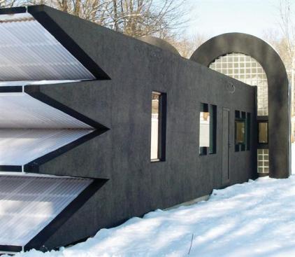 The saw-tooth, polycarbonate-lined light collector sits on one end of the shed roof.