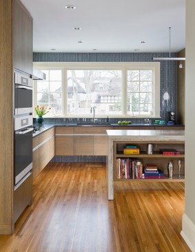 Modern kitchen with rift sawn oak cabinets that hang on wall