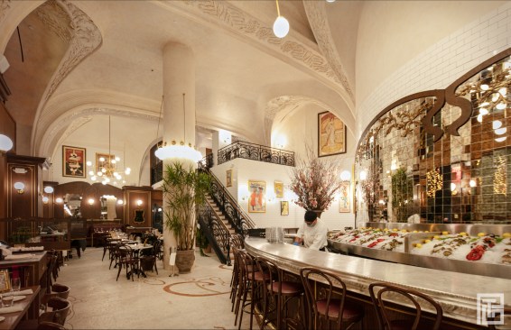 INTERIOR/
The floors throughout the space are a retrospective of Art Nouveau organic, plant forms, taking inspiration from the masters of Art Nouveau like Victor Horta and Antoni Gaudi. An intricate half inch mosaic tile flooring, similar to the arcade, is prevalent at the entrance and the south side of the restaurant, while the north side is an ornamented wood oak marquetry floor. All indoor lighting and chandeliers are designed in the same style as the exterior arcade lighting, displaying a reinterpretation of organic forms.