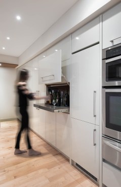 Storage is plentiful along the wall of the kitchen