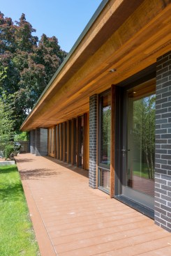 Rear elevation shows large overhang which helps control heat gain in the summer but lets light penetrate deep into the space in winter