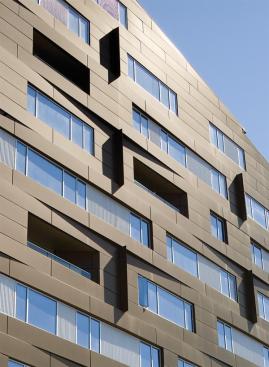 It stands tall and tough in metal cladding to the north, but tips its hat and dons a domestic brick for its eastern face.