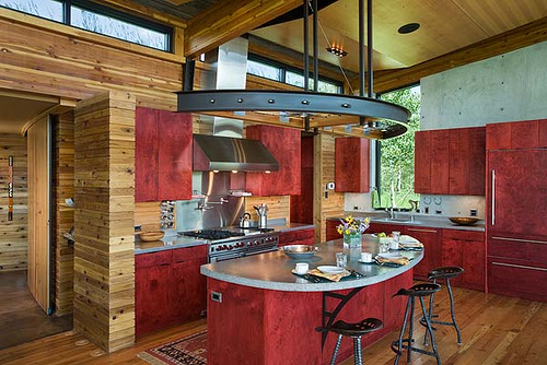 Interior, horizontal, kitchen with red stained Russian birch cabinetry, Landes-Oatey residence, Jackson, Wyoming; Ward + Blake Architects