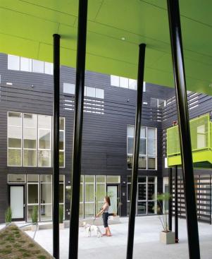 The columns supporting a second story footbridge resemble the bamboo that flourishes in the courtyard 