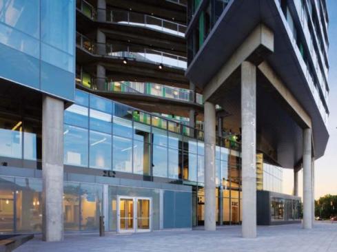 The recessed first and second floors contain many of the building's public functions, including the lobby, theater, and caf?. Sixteen different types of glass are used in the building. The character of the glazing gives a clue to the spaces within: clear glass for public spaces; fritted glass allowing sightlines into the studio spaces, but a modicum of privacy; and more-opaque, colored glass in the residential areas.