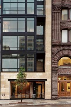 A narrow band of stone tempers the heavy, rustic style of the building next doo.