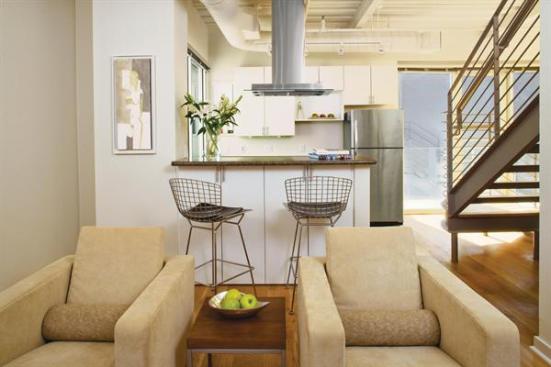 Glass walls and balconies and open-tread stairs create light-filled interiors.