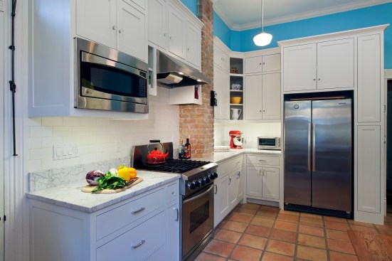 After: new storage and cabinets were built around the element from the original wood burning stove  
