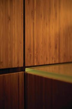 The main retail space is dominated by glass-topped custom bamboo plywood counters and cabinetry.