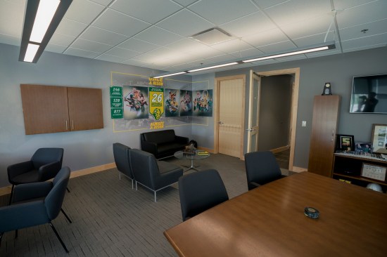 Storytelling wall covering graphics integrate the brand into office spaces at the SHAC