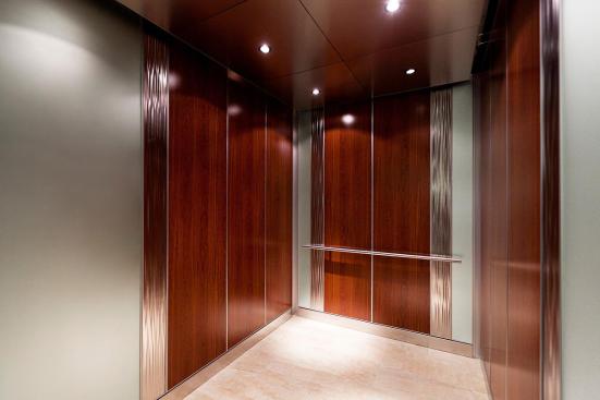 Custom LEVELe-101 Elevator Interior with custom main inset panels; outer accent panels in ViviChrome Chromis glass with Mirror Mist interlayer and Opalex finish; inner accent panels in Stainless Steel with Seastone finish and Kalahari pattern at MIT - Massachusetts Institute of Technology, Cambridge, Massachusetts