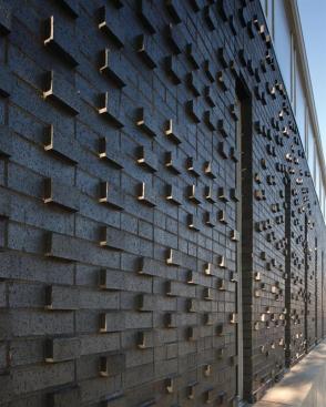 The textured brick facade makes abstract reference to the masonry of older neighborhood buildings.
