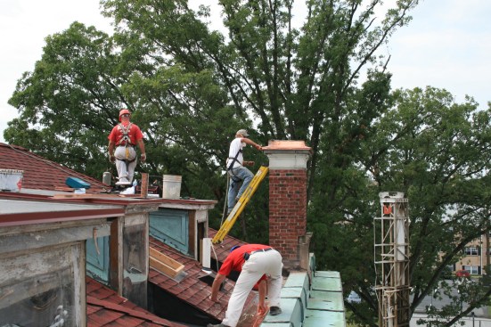 Workers restoring the roof