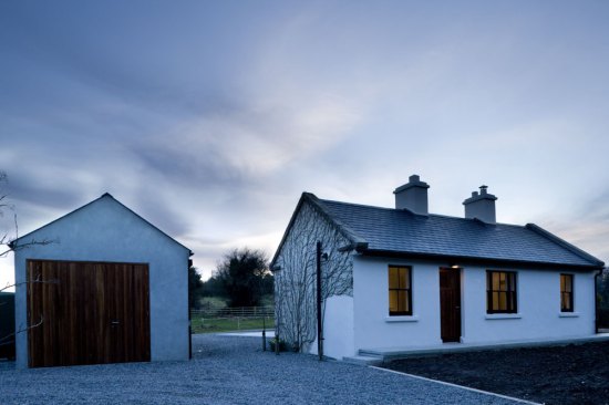 Overlapping arrangement of garage and existing house to create an enclosed courtyard.
