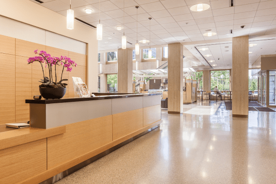 Reception desk and wall accents in ViviChrome Chromis glass with Taupe interlayer and Opalex finish at Lloyd Center Tower, Portland, Oregon