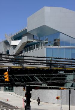 View of the south and east facades from across the elevated train tracks.