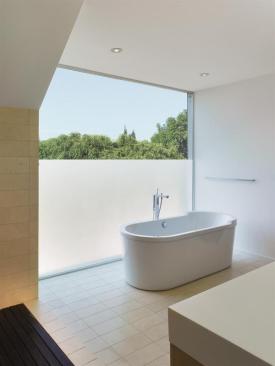 The glass window in the master bath offers privacy from the street but still permits light. 