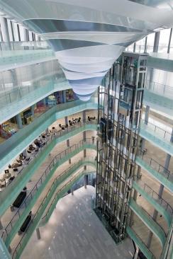 The southern end of the building is dominated by a full-height atrium, which is capped by a vortex-like lighting installation that descends from the ceiling.