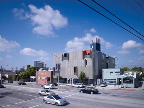 The mixed-use, infill project features retail and parking on the ground floor and an underground parking level.