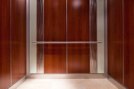 Custom LEVELe-101 Elevator Interior with custom main inset panels; outer accent panels in ViviChrome Chromis glass with Mirror Mist interlayer and Opalex finish; inner accent panels in Stainless Steel with Seastone finish and Kalahari pattern at MIT - Massachusetts Institute of Technology, Cambridge, Massachusetts
